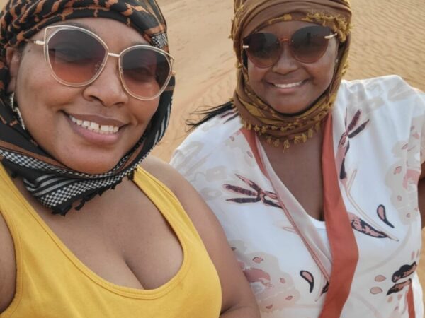 Two women smiling in a desert safari. Dubai travel.