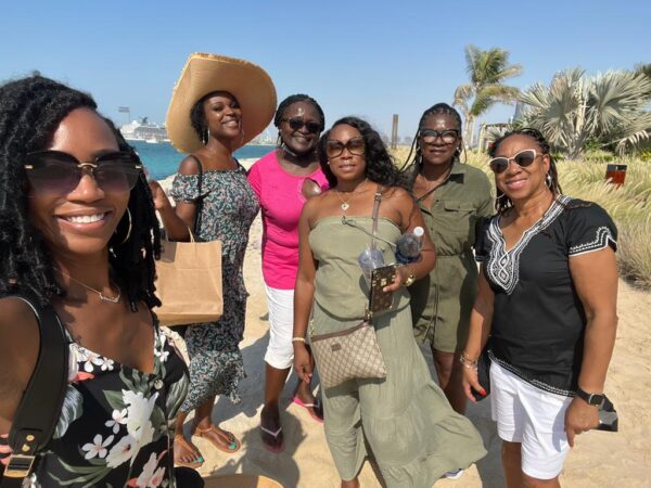 Group of women smiling on the beach. Group travel